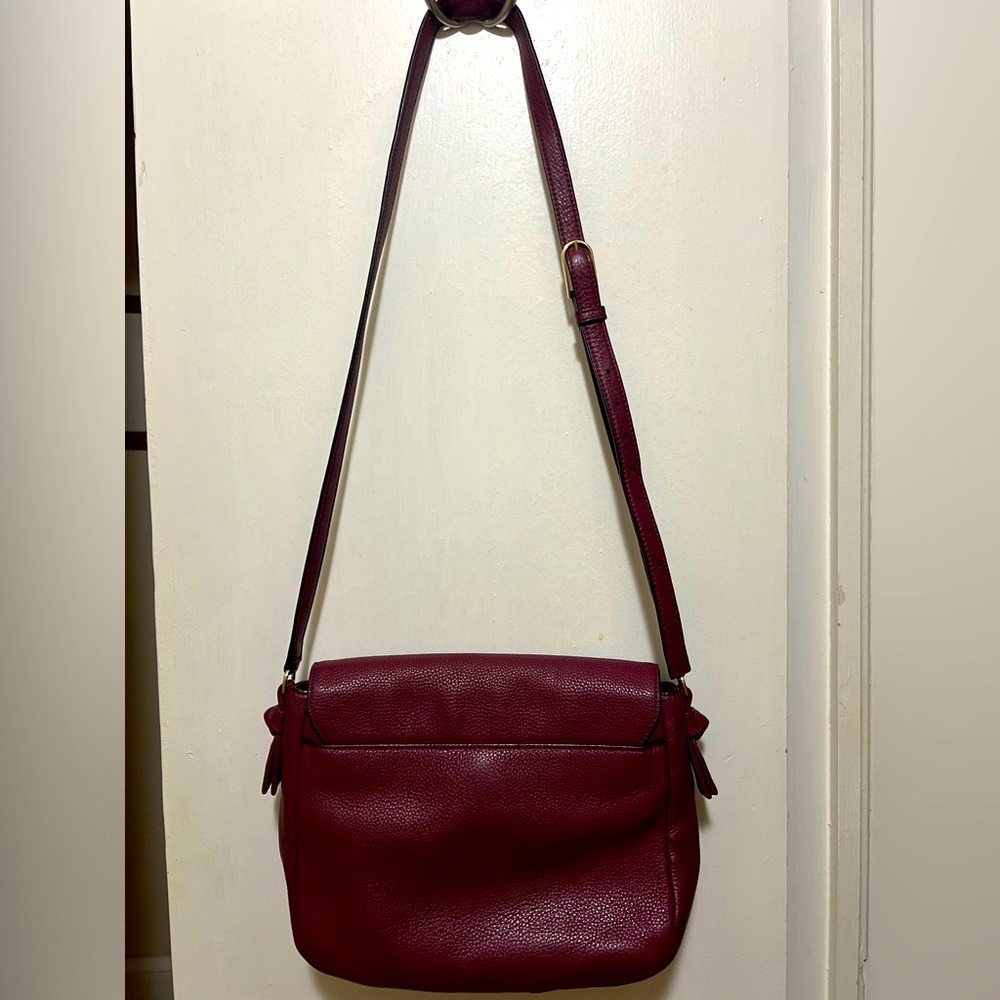 A beautiful burgundy/maroon Tory Burch cross body purse. - Picture 2 of 7